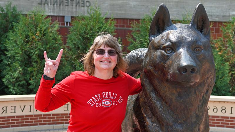 Provost Zink doing the sign of the Husky