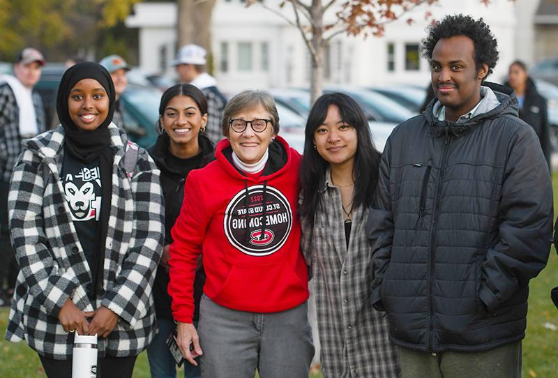 President Robbyn Wacker and students at the Homecoming bonfire