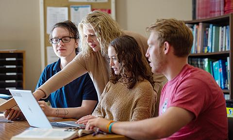 Students and faculty work on a computer at SCSU