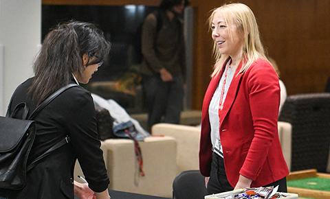 A volunteer speaks with an SCSU student