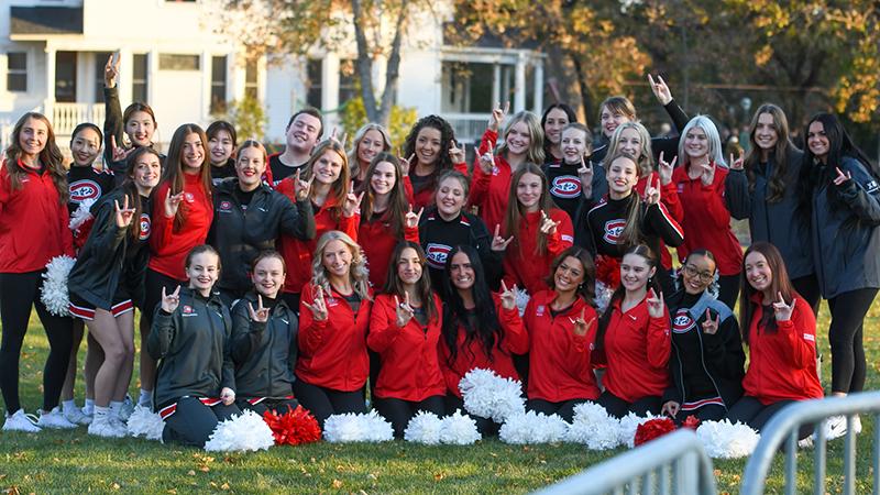 Cheer team doing sign of Husky