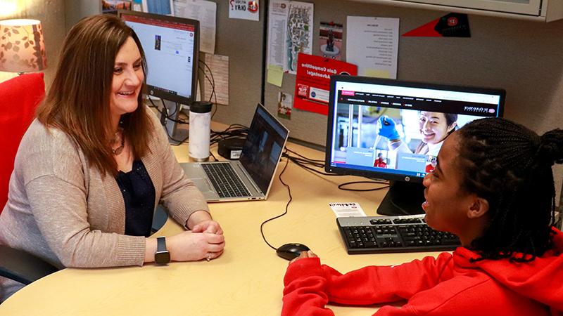 Student talking to staff member